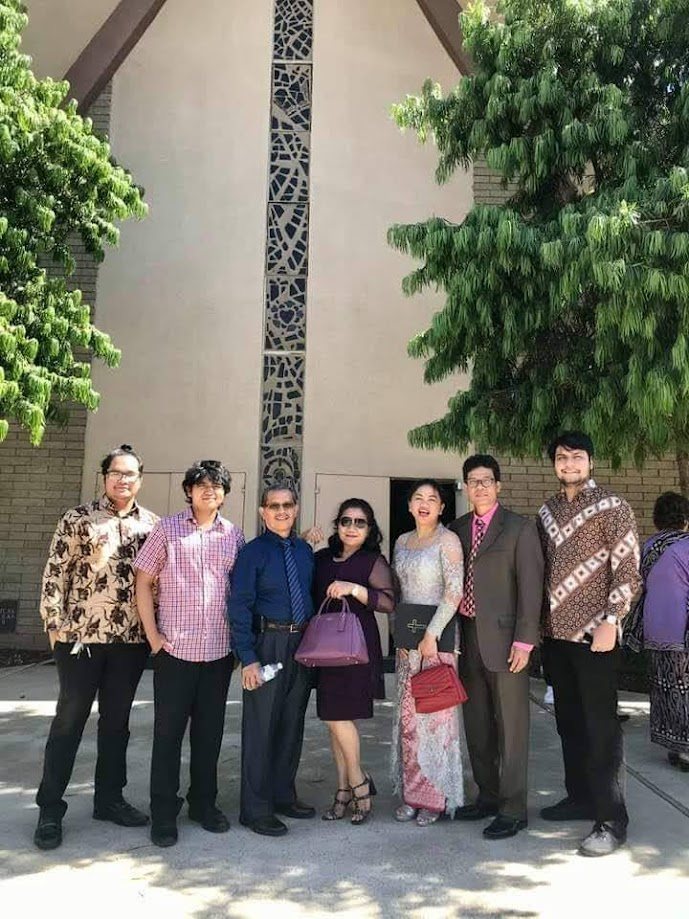 Family outside the church in traditional Indonesian dress