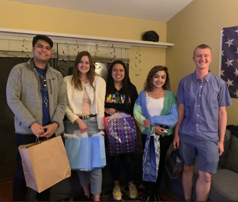 Five students holding gift bags at a chapter gathering
