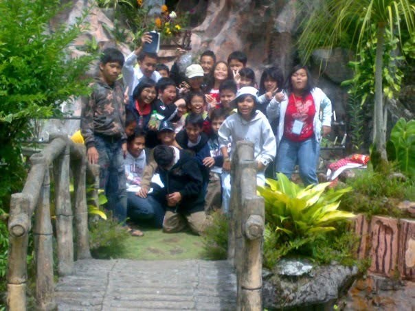 The whole group crowded onto the steps of a garden on our middle school retreat