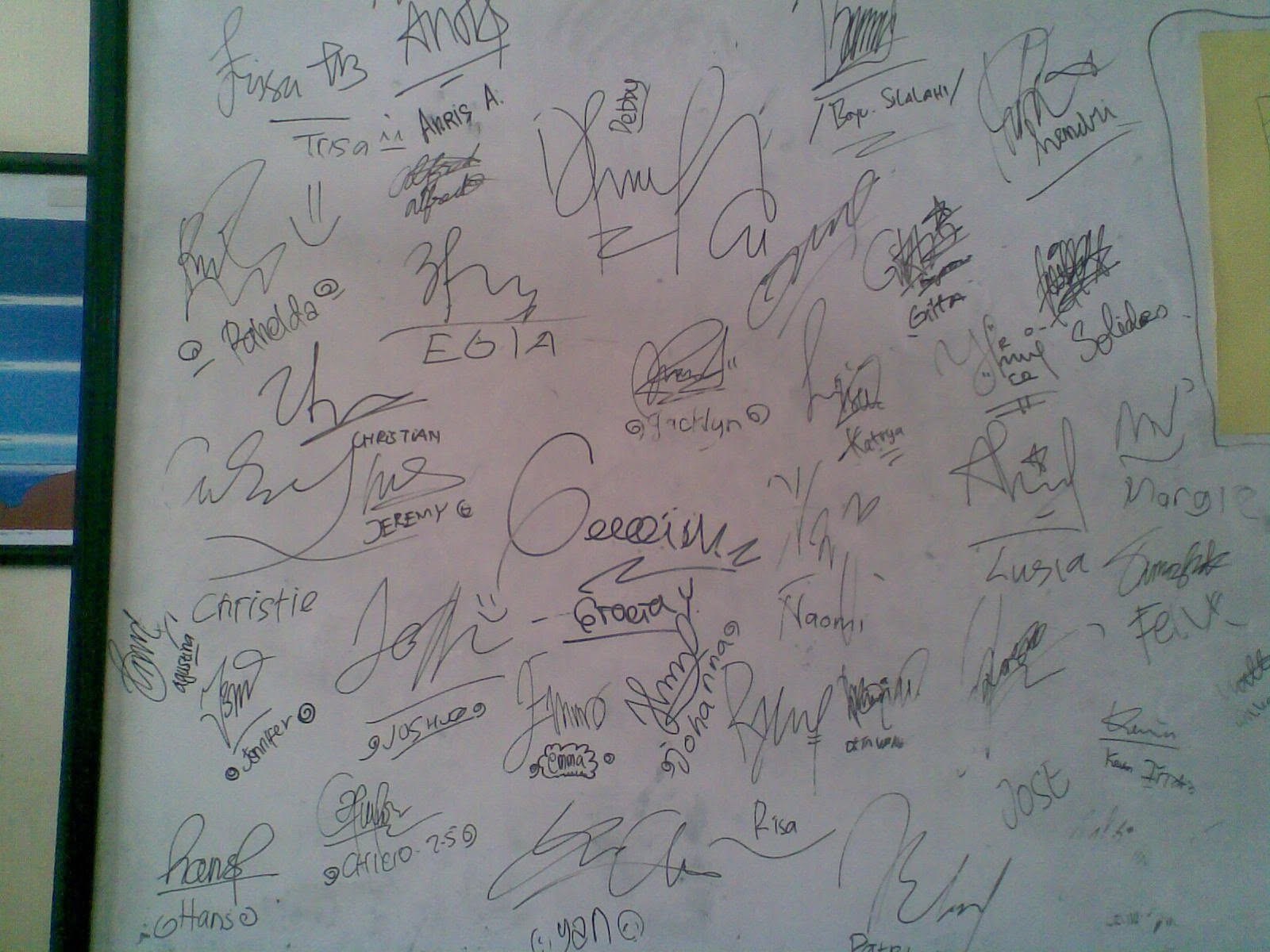 A whiteboard covered end to end in the class signatures