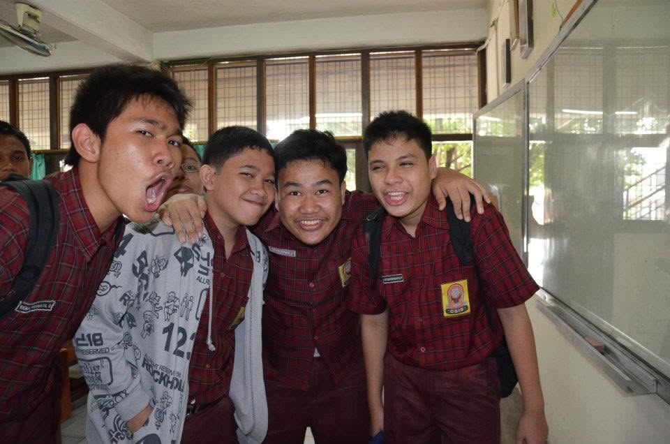 Four of us crowded together at the front of the classroom, pulling faces