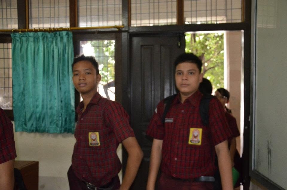 Two of us walking out of the classroom in the plaid uniform