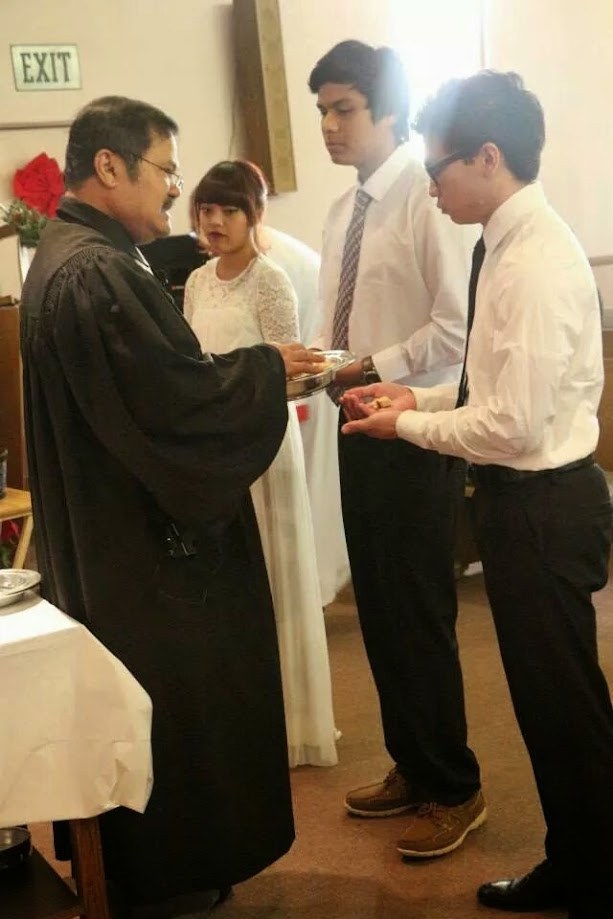 A minister serving at the front of the sanctuary during a service