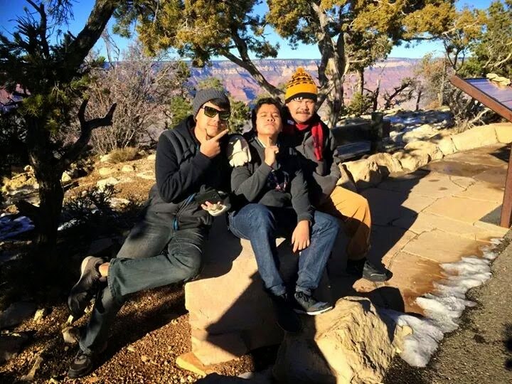 Three of us sitting on a rock at the Grand Canyon in winter