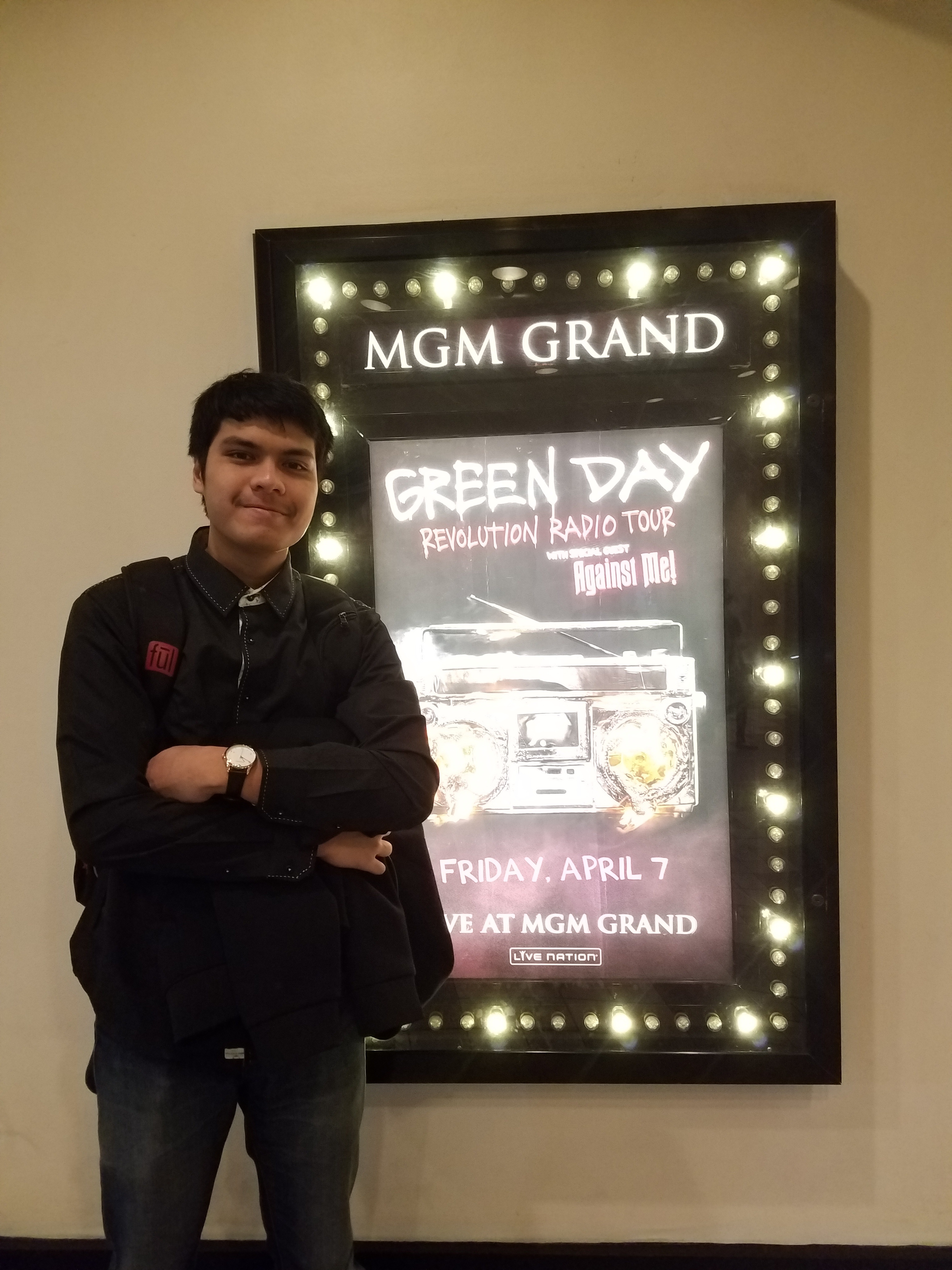 Standing beside the Green Day Revolution Radio Tour poster at the MGM Grand