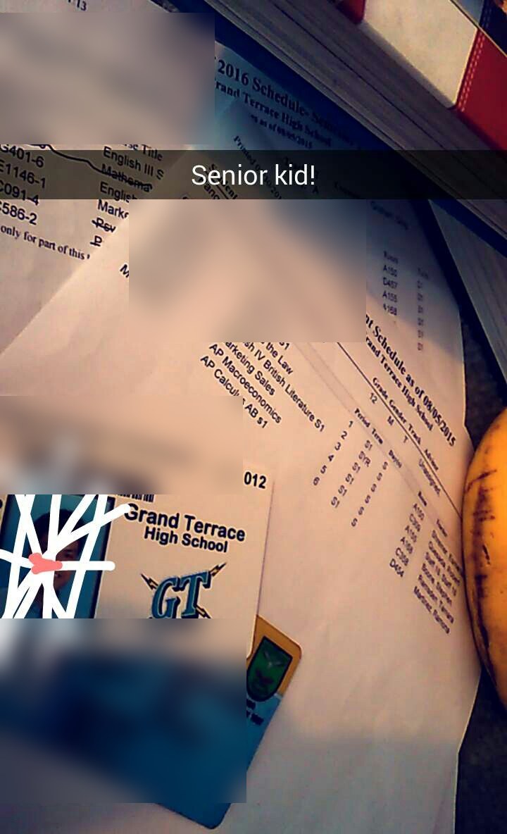 My senior year class schedule and school ID on the desk, next to a banana