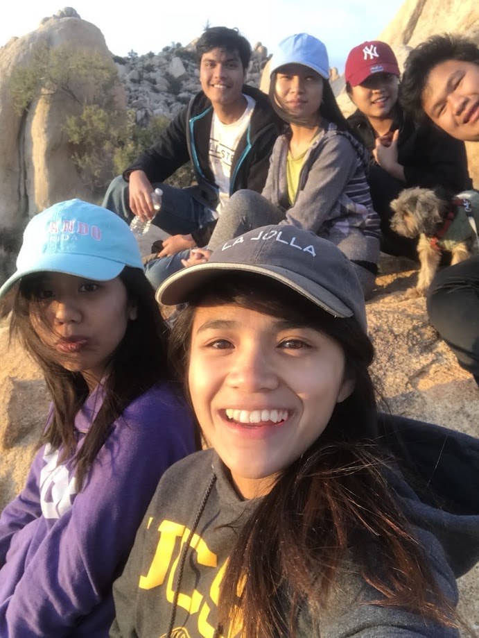 Selfie with friends and a dog on the rocks during a desert hike