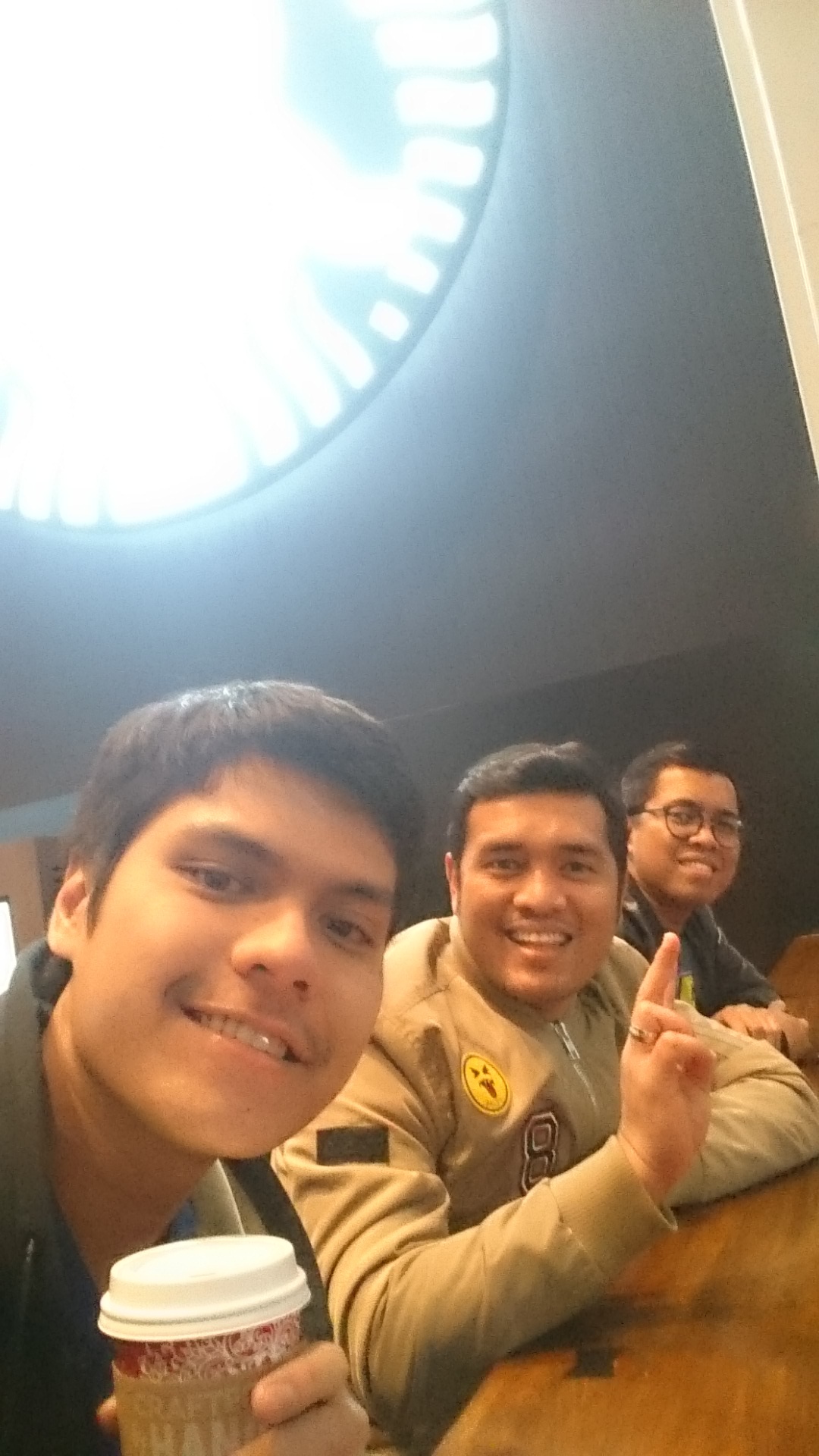 Three of us squeezed into a selfie at a coffee shop table