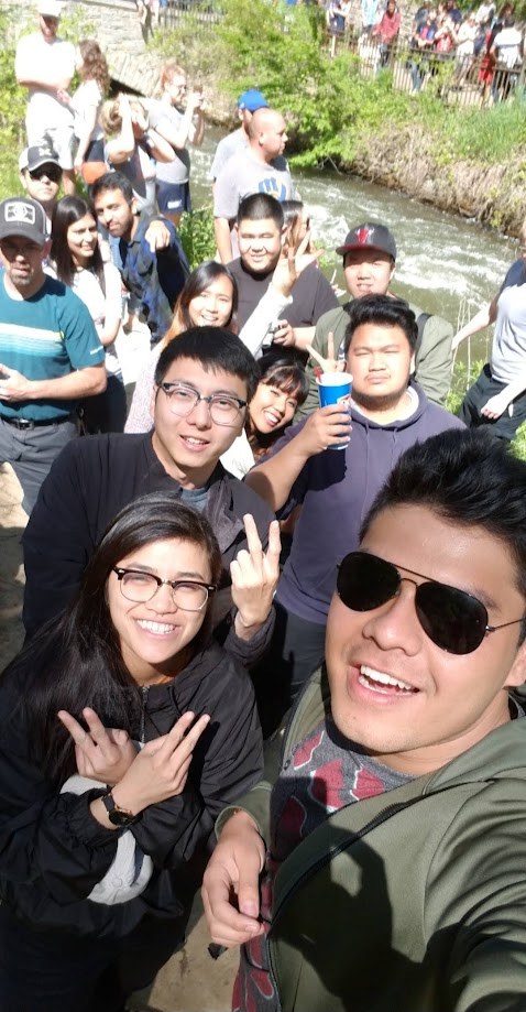Group selfie beside a creek on a sunny day