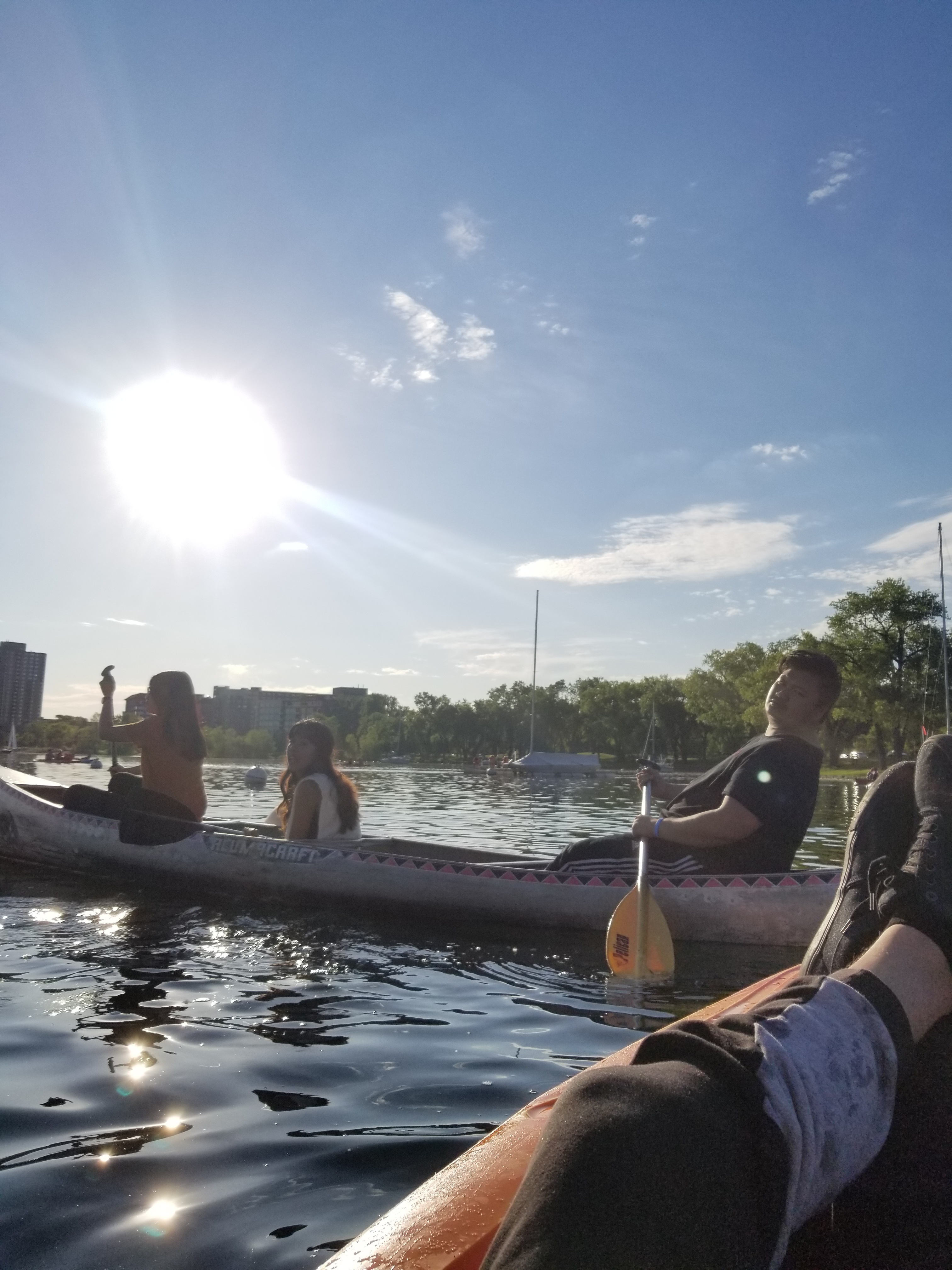 Paddling a canoe on a lake in the late afternoon sun