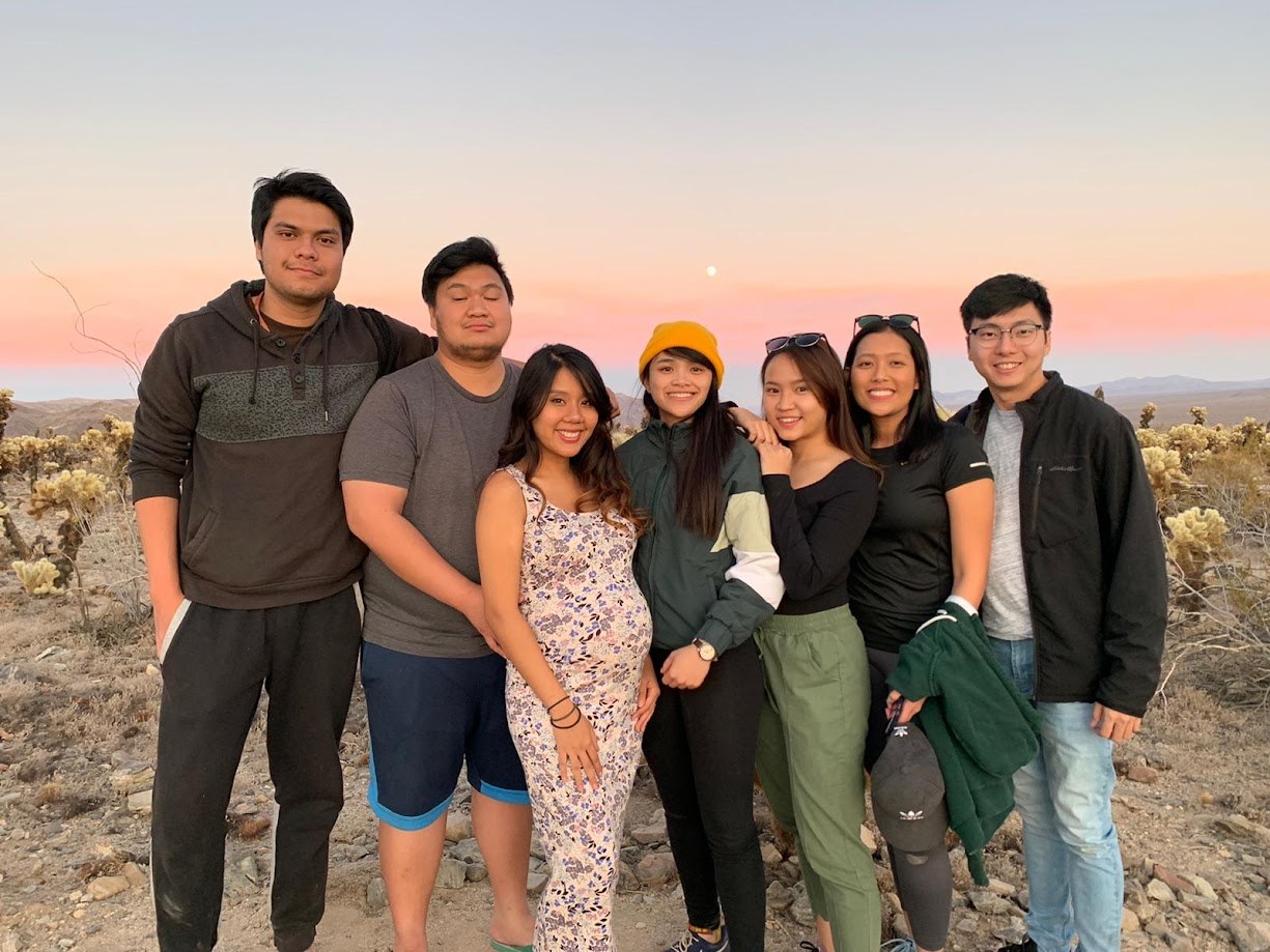 Seven of us together in the desert at sunset, cholla cactus and the moon behind us