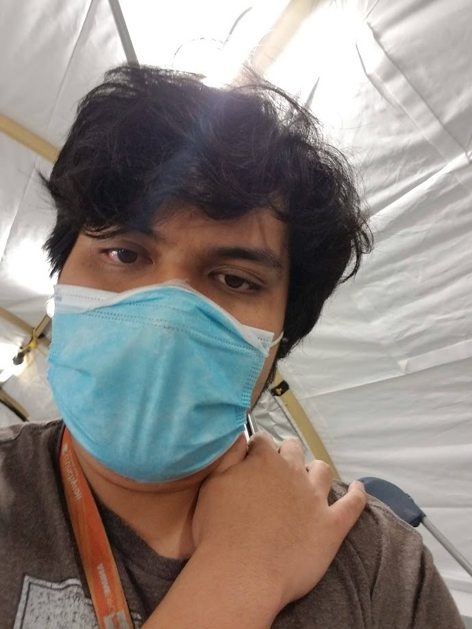 Masked selfie inside a white tent