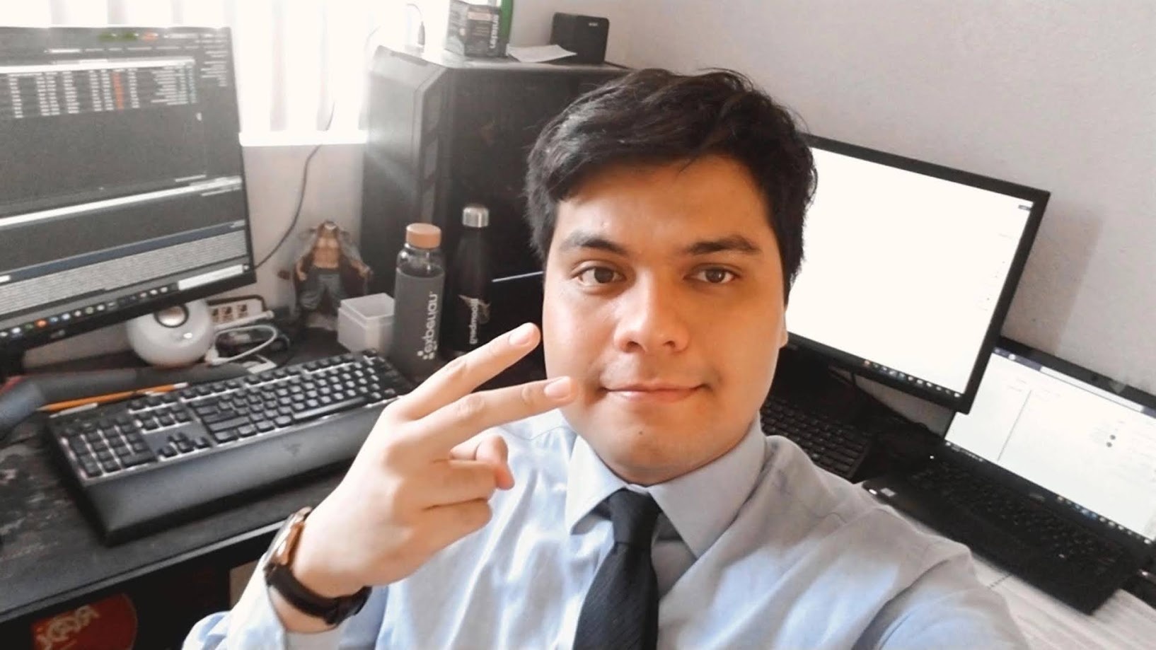Selfie in shirt and tie at the home desk between calls
