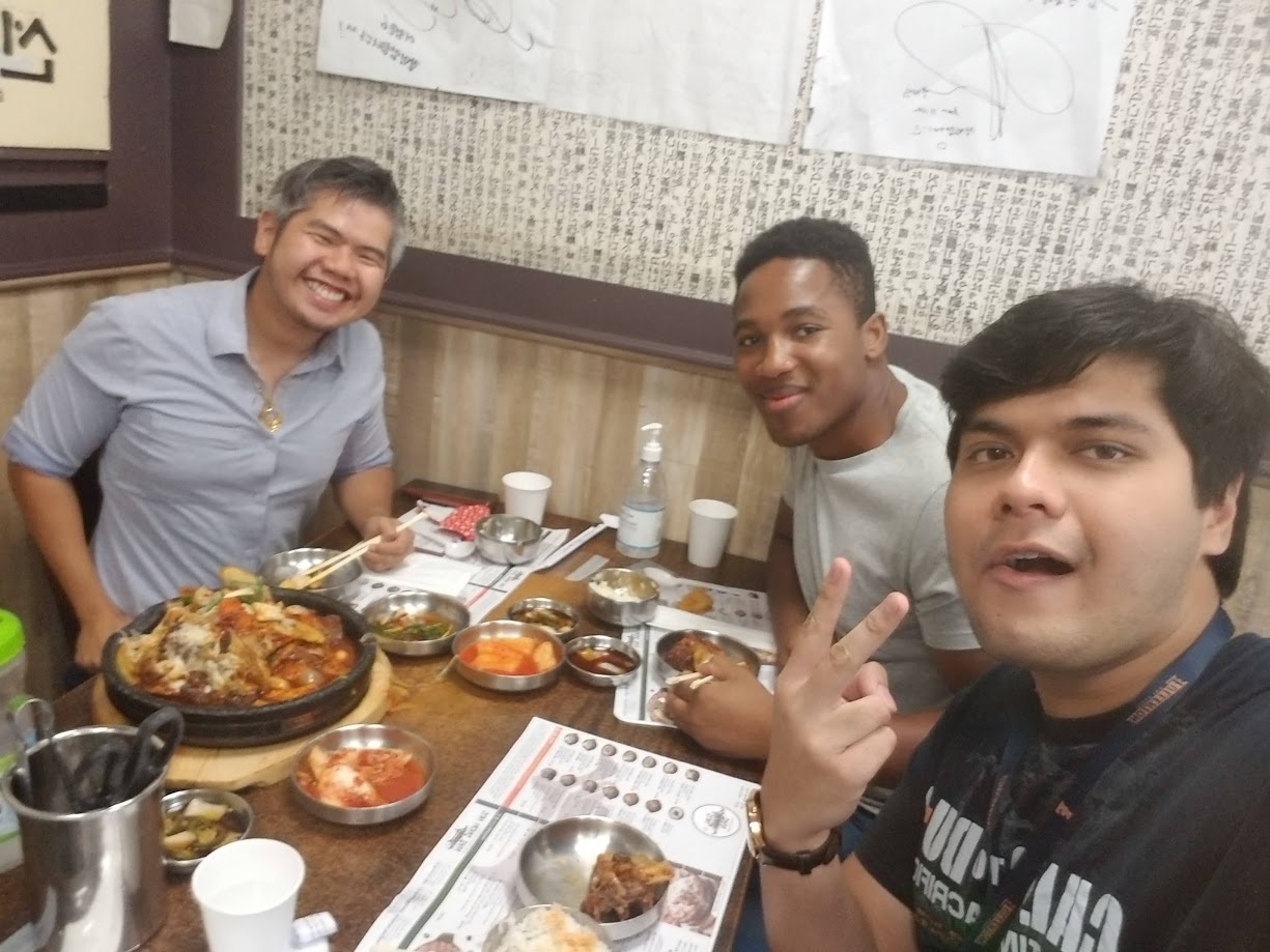 Sharing a stone pot of Korean food with two friends