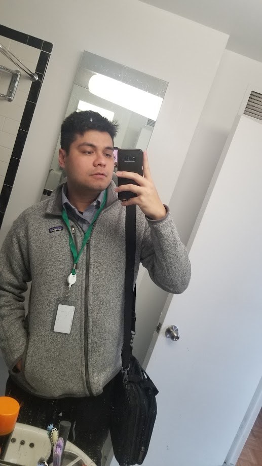 Mirror selfie with the office badge and laptop bag