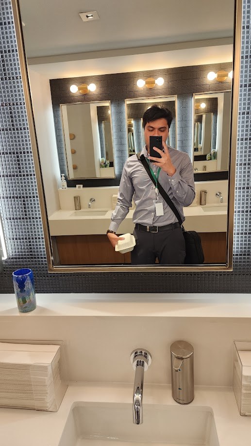 Selfie in the office restroom mirror in a dress shirt