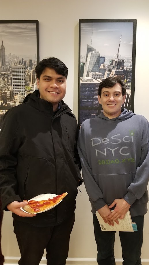 At a DeSci NYC meetup, pizza in hand