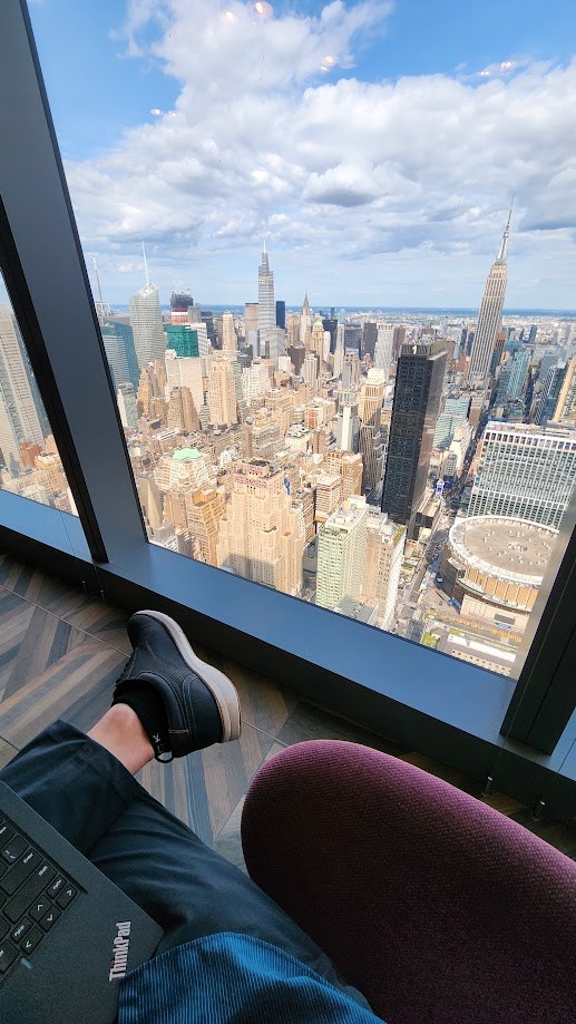 Feet up beside the laptop with midtown and Madison Square Garden far below
