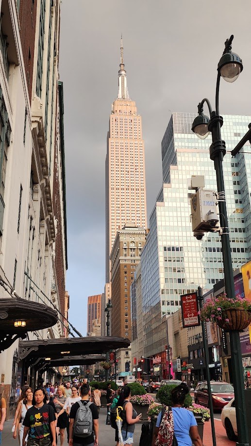 The Empire State Building at the end of a crowded midtown block