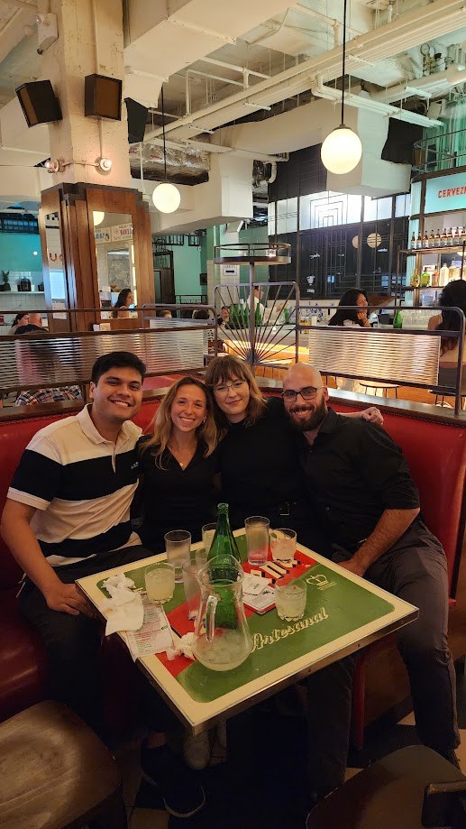 Squeezed into a red booth at the food hall with three friends