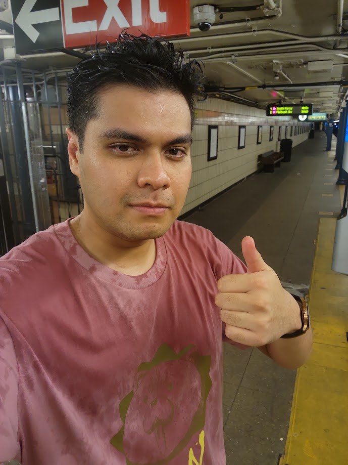 Thumbs up on the subway platform, shirt soaked through from the walk