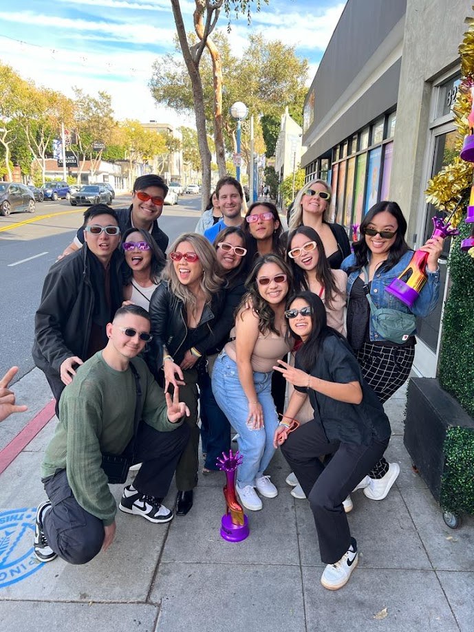 Group on a sunny Los Angeles sidewalk, everyone in sunglasses