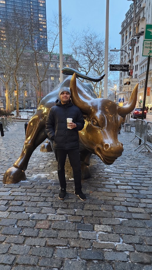 Beside the Charging Bull on a winter morning with a coffee in hand