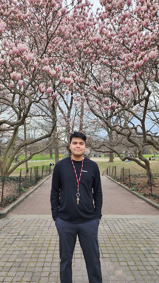 Standing under magnolia trees in full bloom in Central Park