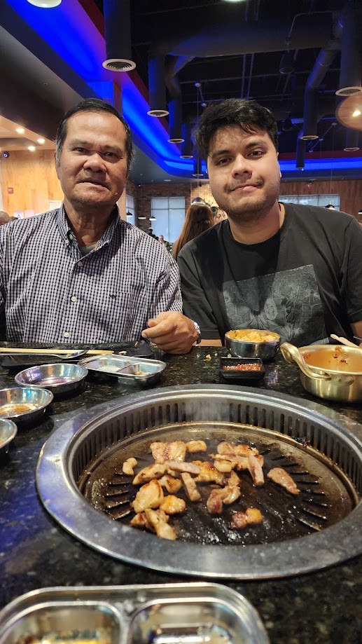 With my father over the grill at a Korean barbecue table