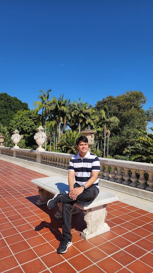 Sitting on a stone bench on the terrace at Hearst Castle under a blue sky
