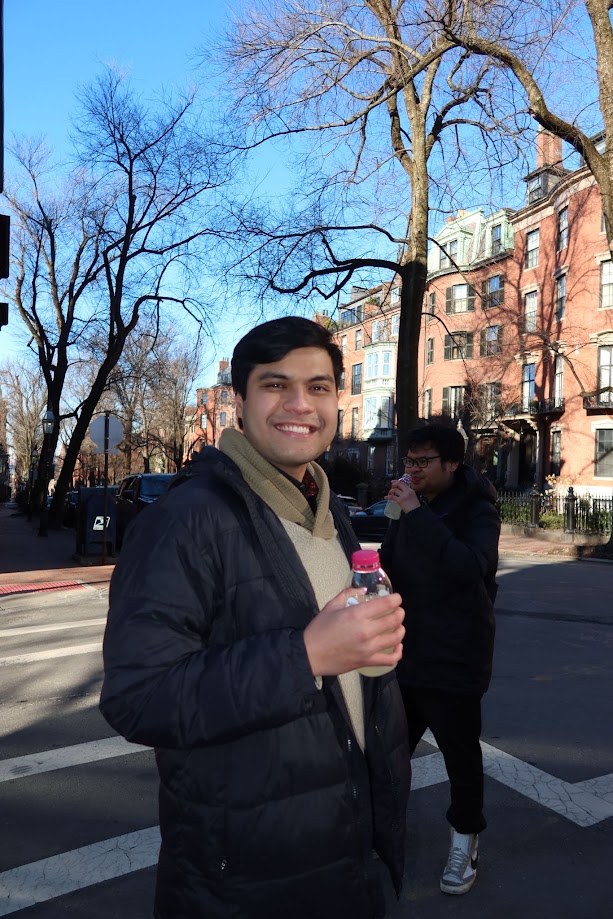 Crossing a Back Bay street in the winter sun with a drink in hand