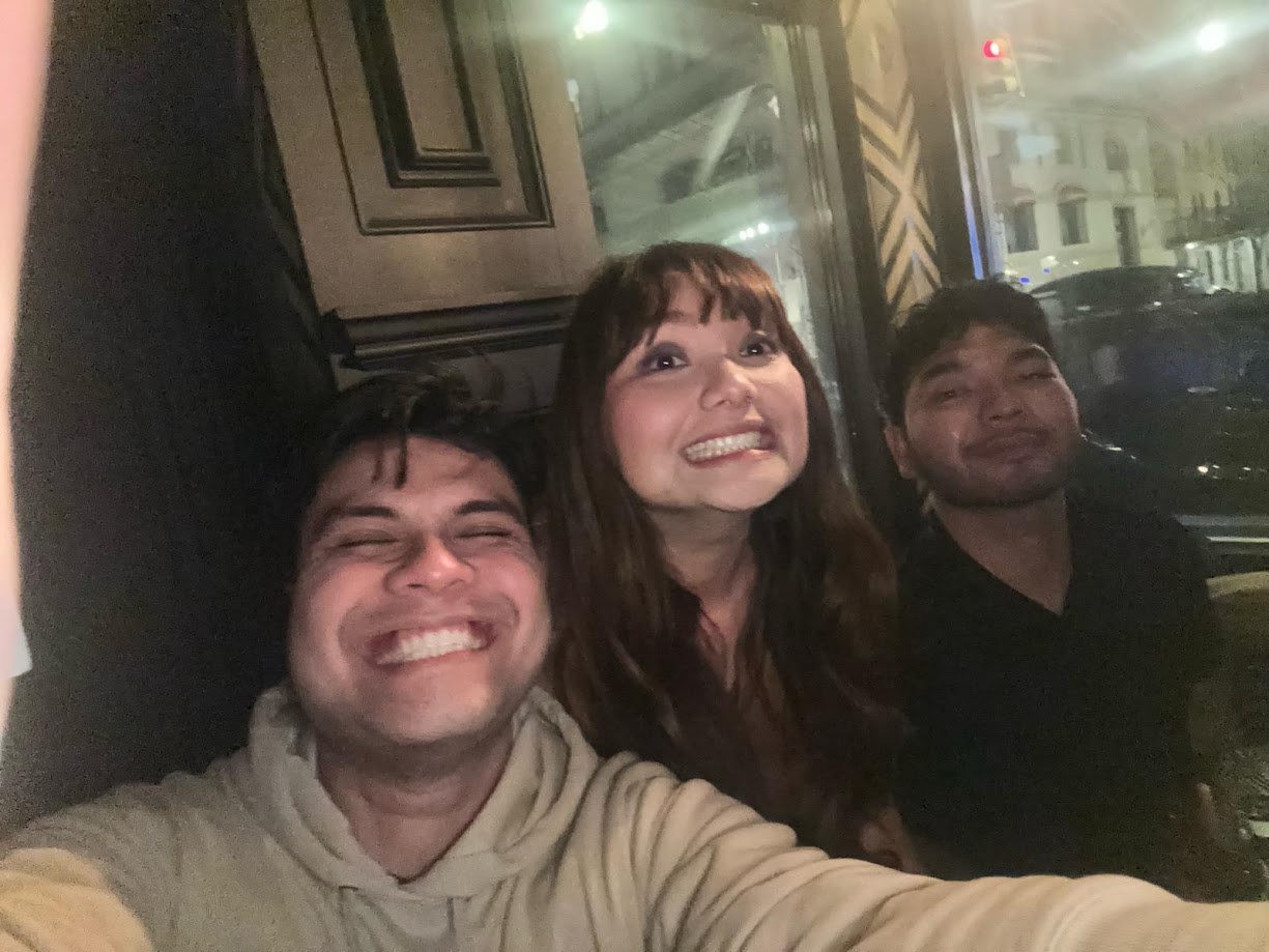Three of us laughing in a bus window seat at night