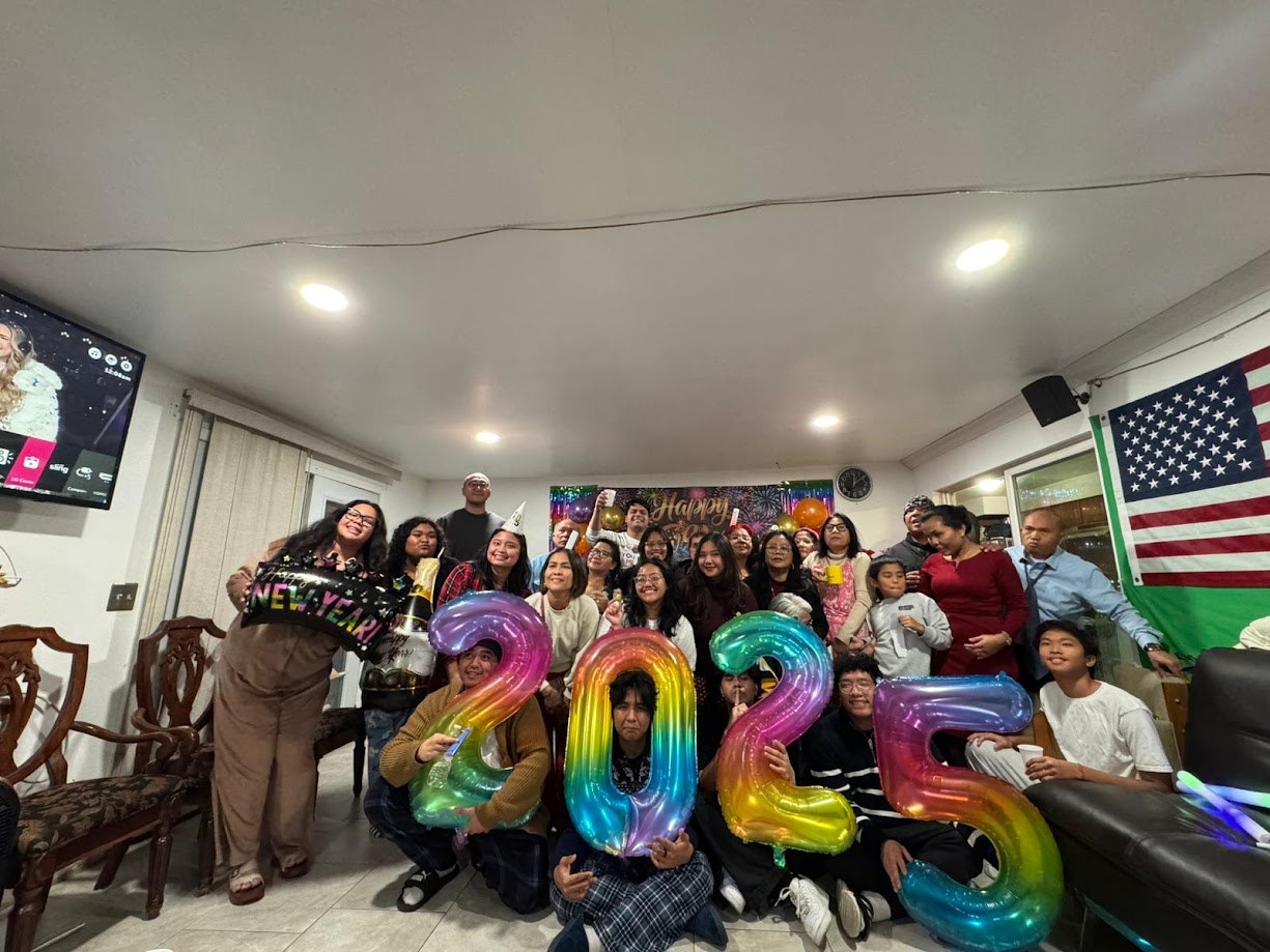 The whole house behind a set of balloons that read 2025