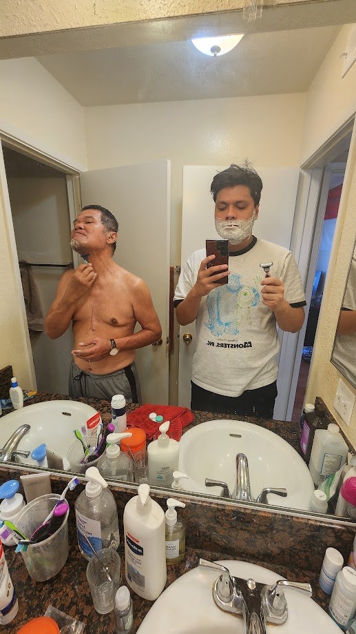 Shaving at the mirror next to my dad, both of us with foam on