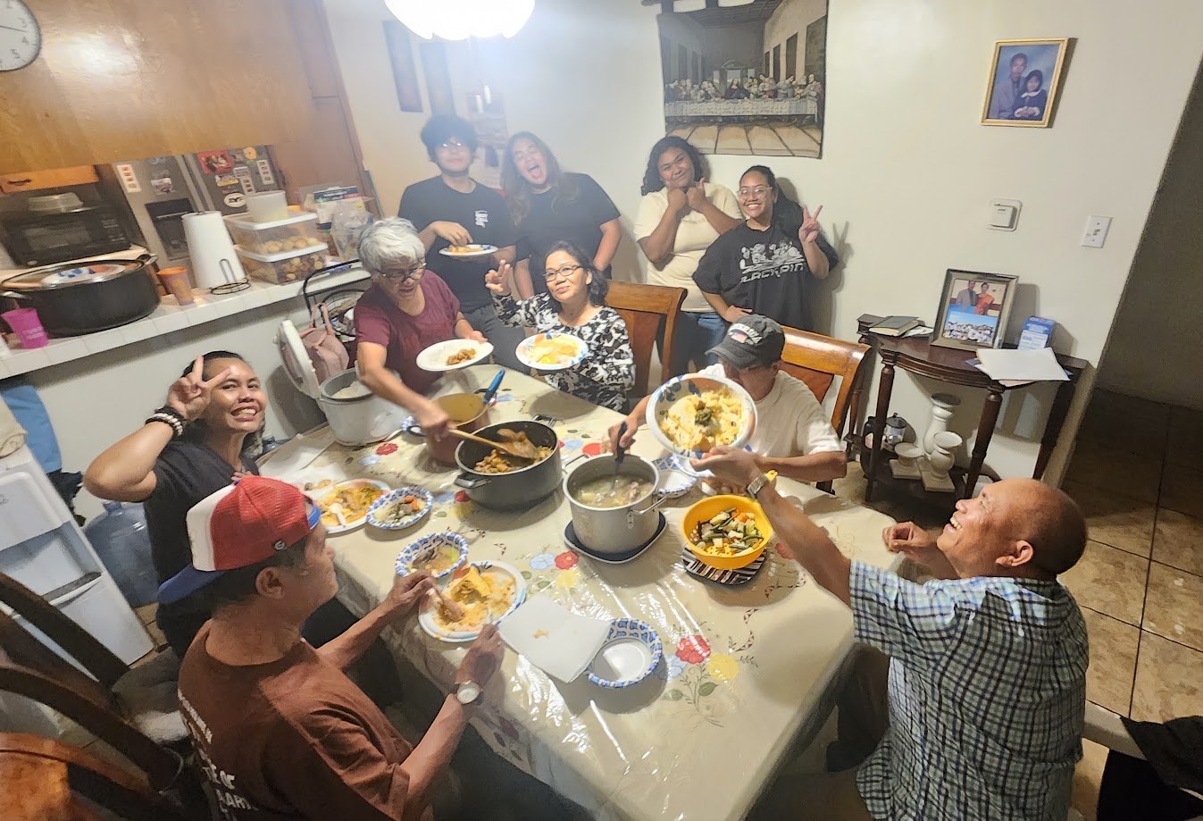 Family around the table at home, plates and pots everywhere