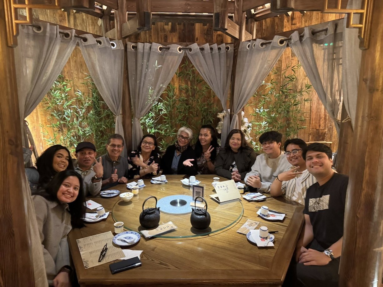A big family gathering packed into a wooden Korean-style booth