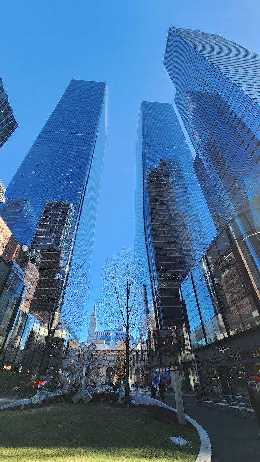 Looking up between the Hudson Yards towers past a snowflake sculpture