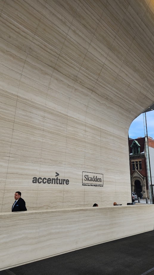 The stone reception wall of the Accenture and Skadden lobby