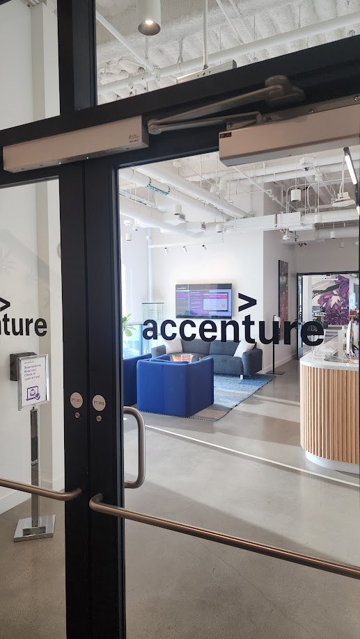 The Accenture office seen through the glass doors from the corridor