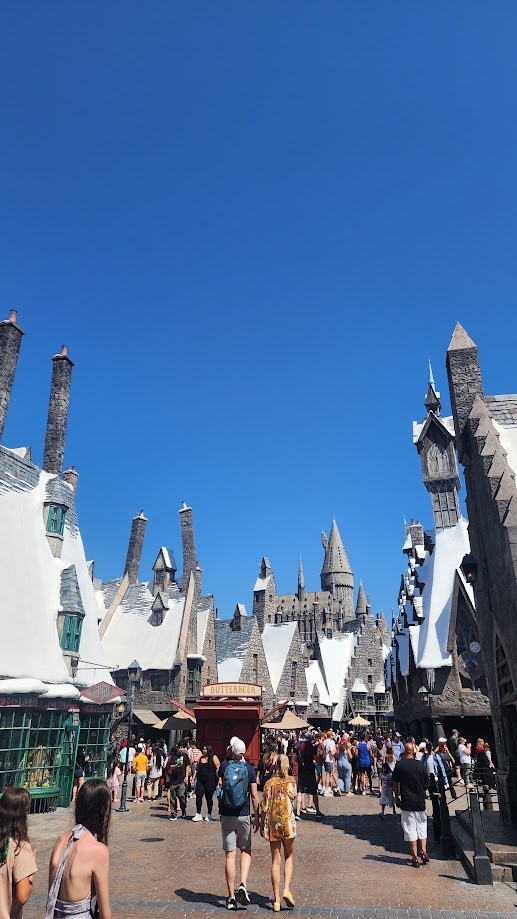 The Hogsmeade street with the castle spires rising behind it