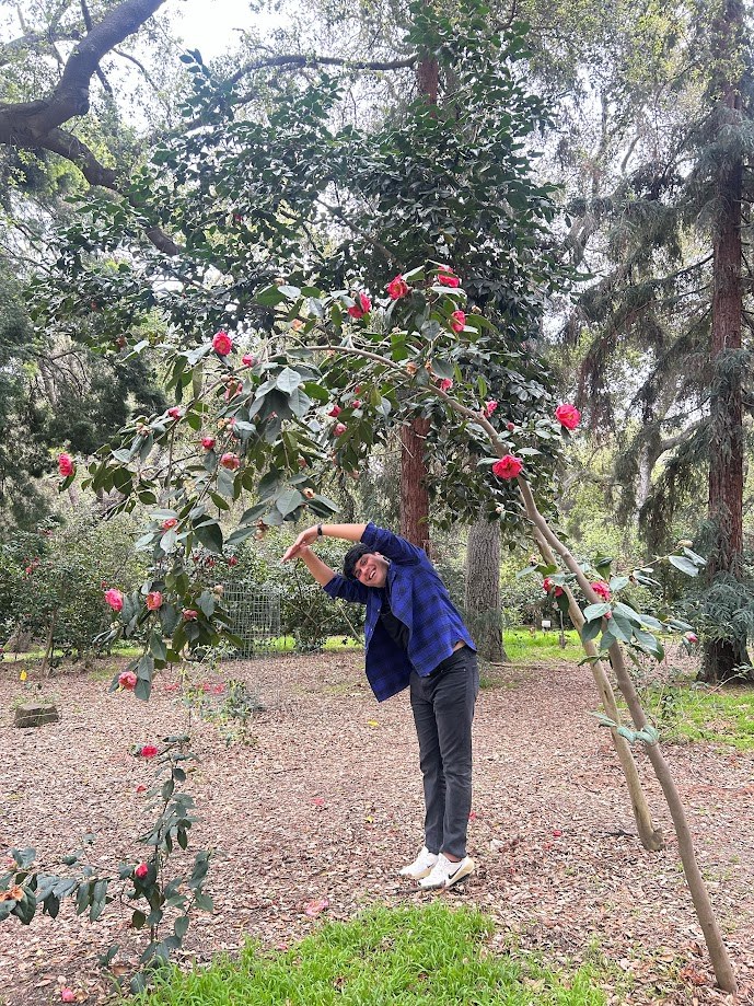 Posing under a camellia tree in bloom