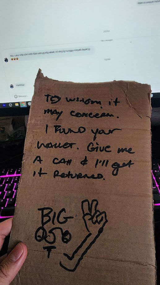 A cardboard sign I made that reads, to whom it may concern, I found your wallet, give me a call and I will get it returned