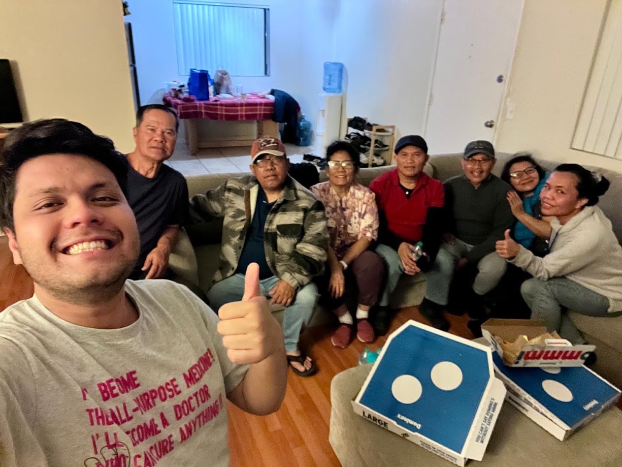Selfie with everyone lined up on the couch, Domino's boxes on the table