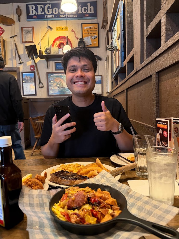 Steak, mac and cheese and a skillet across the table, thumbs up