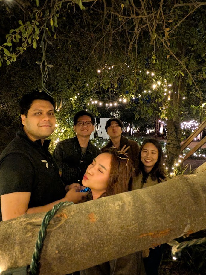 Five of us at night under the string lights