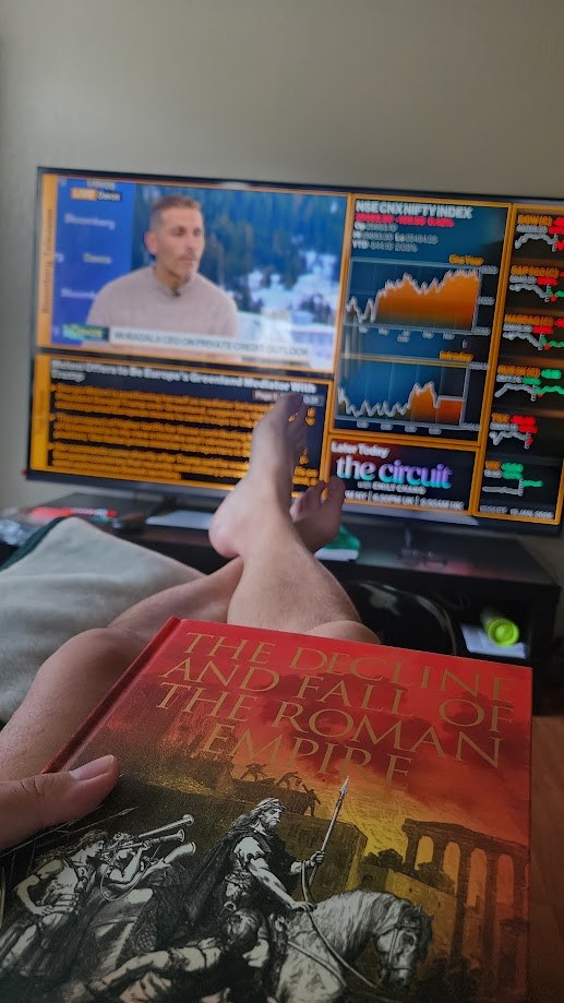 Feet up with Gibbon's Decline and Fall in hand and Bloomberg running on the screen