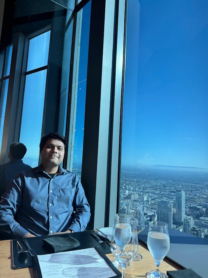 Sitting by the window of a high floor restaurant with Los Angeles spread out below